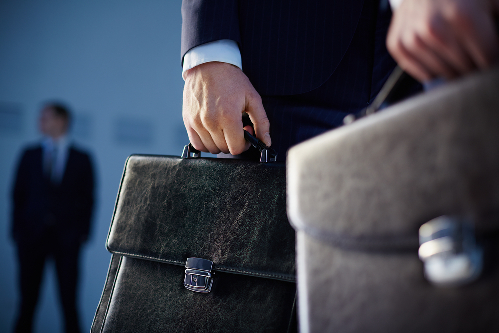Cropped,Image,Of,Business,Partners,Carrying,Briefcases,On,The,Foreground